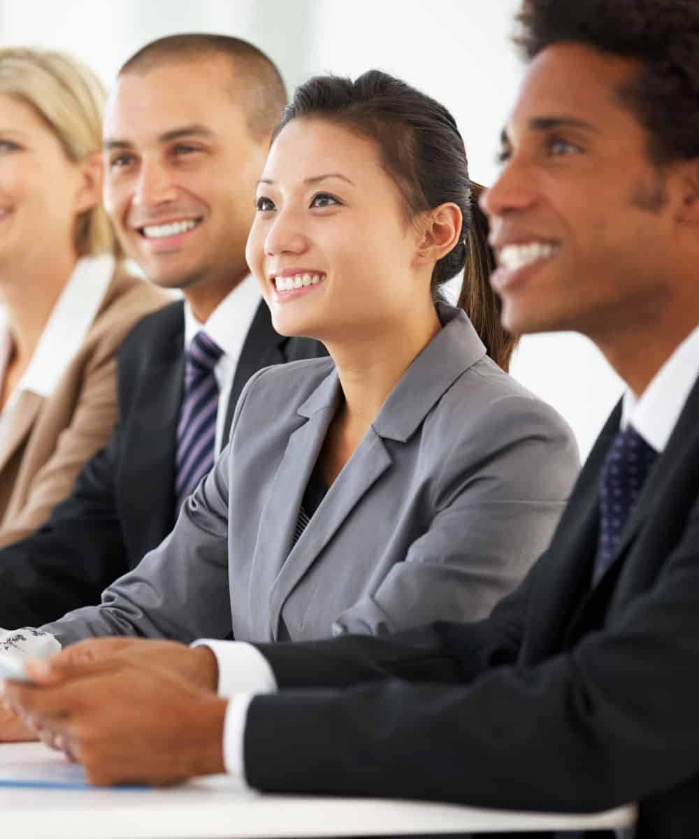 Corporate Workers Smiling Engaged In Listening